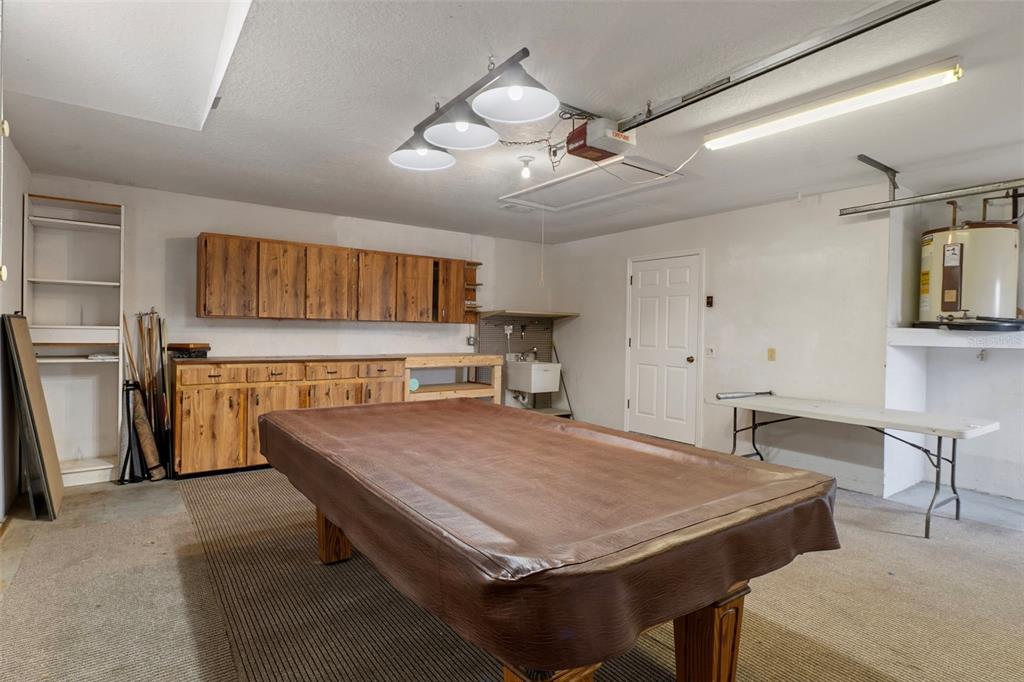 2214 Meadow Lark Road Spring Hill, FL 34608 - Photo 37 of 49 a room with kitchen island a wooden floor and stainless steel appliances