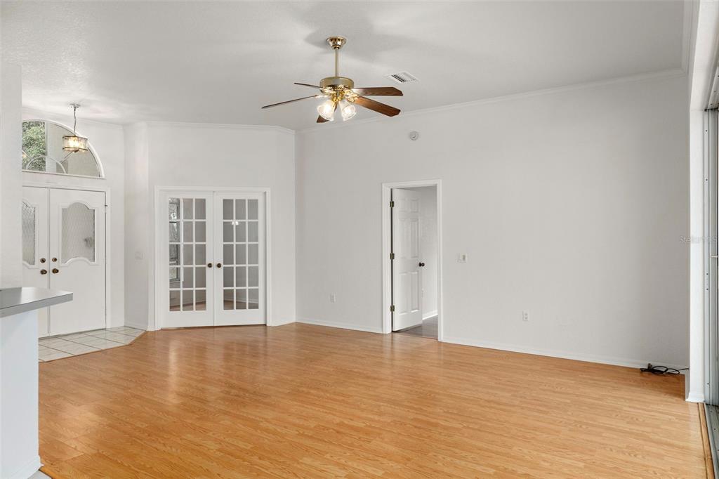 2214 Meadow Lark Road Spring Hill, FL 34608 - Photo 4 of 49 wooden floor in an empty room with a window