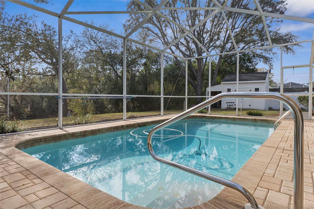 2214 Meadow Lark Road Spring Hill, FL 34608 - Photo 42 of 49 a view of a swimming pool with a yard