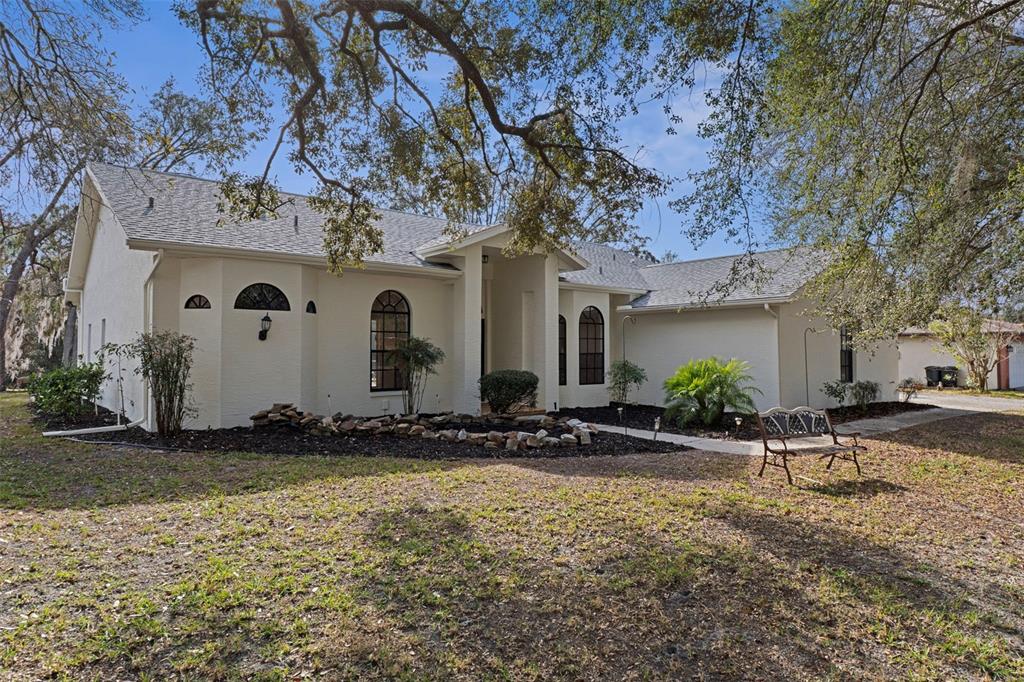 2214 Meadow Lark Road Spring Hill, FL 34608 - Photo 7 of 49 a front view of a house with garden