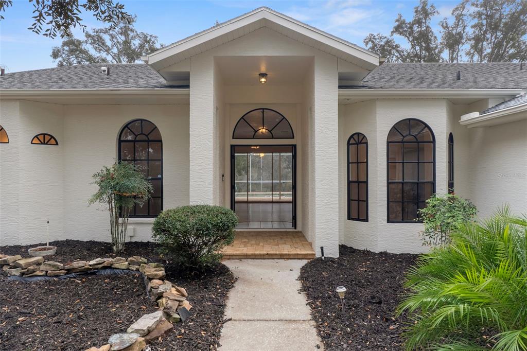 2214 Meadow Lark Road Spring Hill, FL 34608 - Photo 8 of 49 a front view of a house with garden