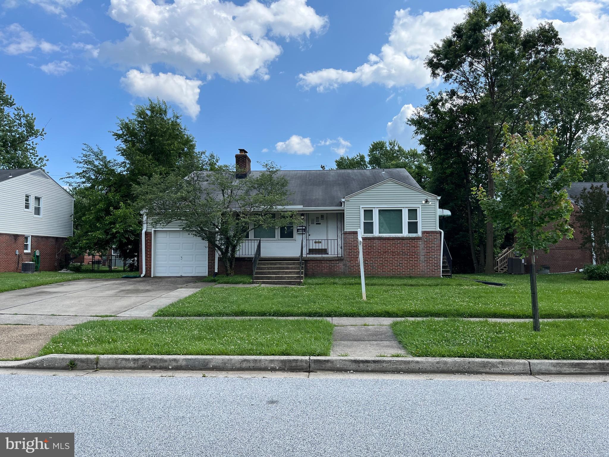 3109 Northbrook Road Baltimore, MD 21208 - Photo 1 of 23 a front view of a house with a yard and garage