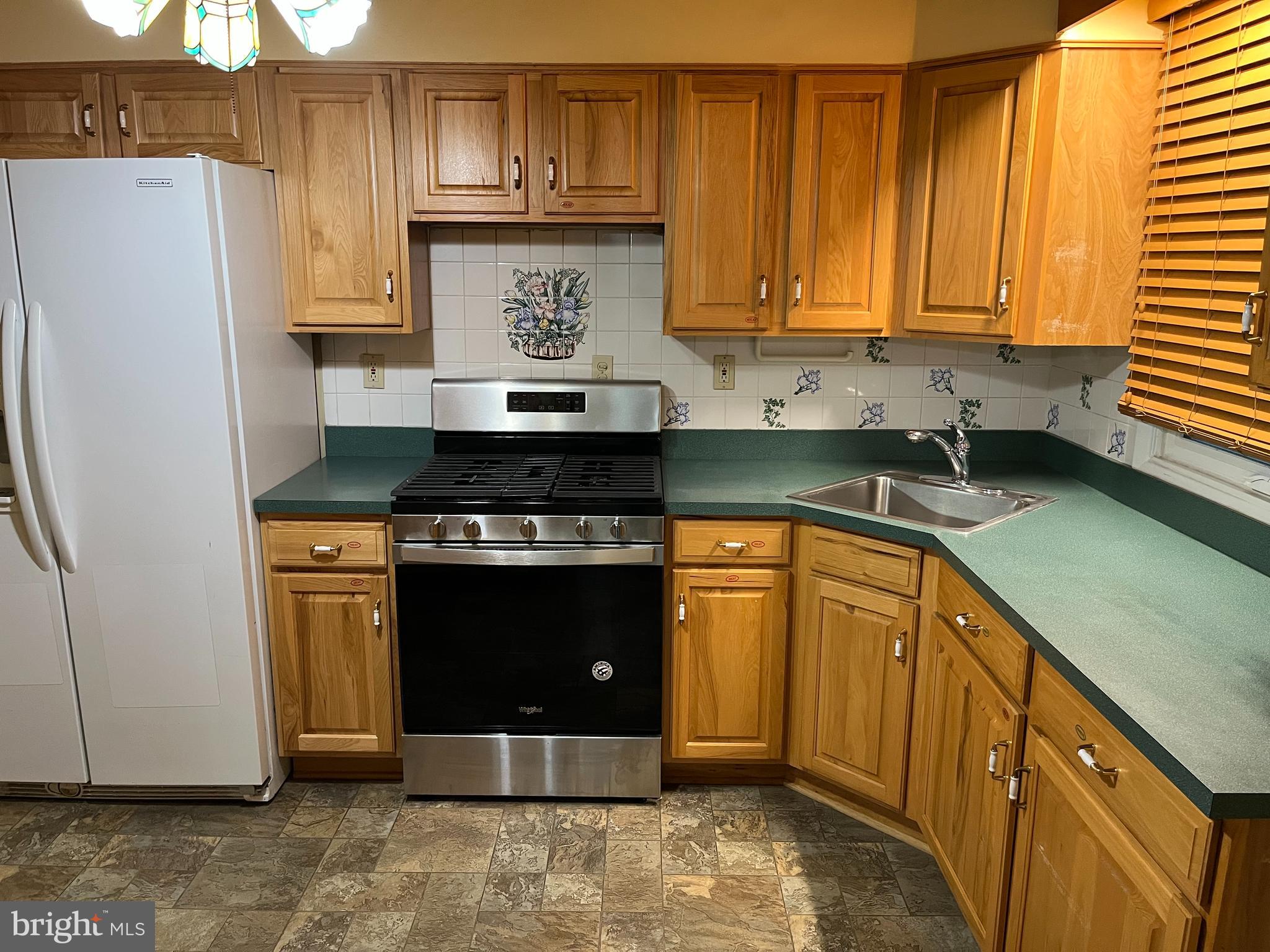 3109 Northbrook Road Baltimore, MD 21208 - Photo 6 of 23 a kitchen with stainless steel appliances granite countertop a stove and a refrigerator