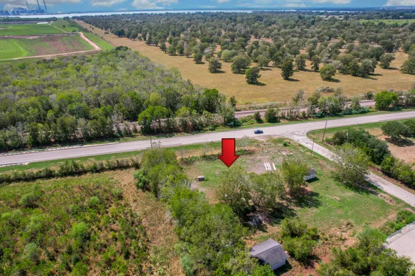 an aerial view of red house with outdoor space