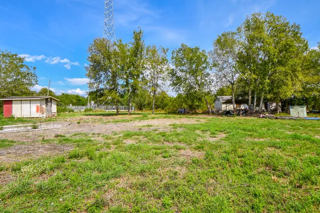 a view of outdoor space with garden and trees