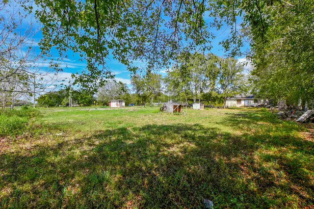 a view of a green field with lots of bushes