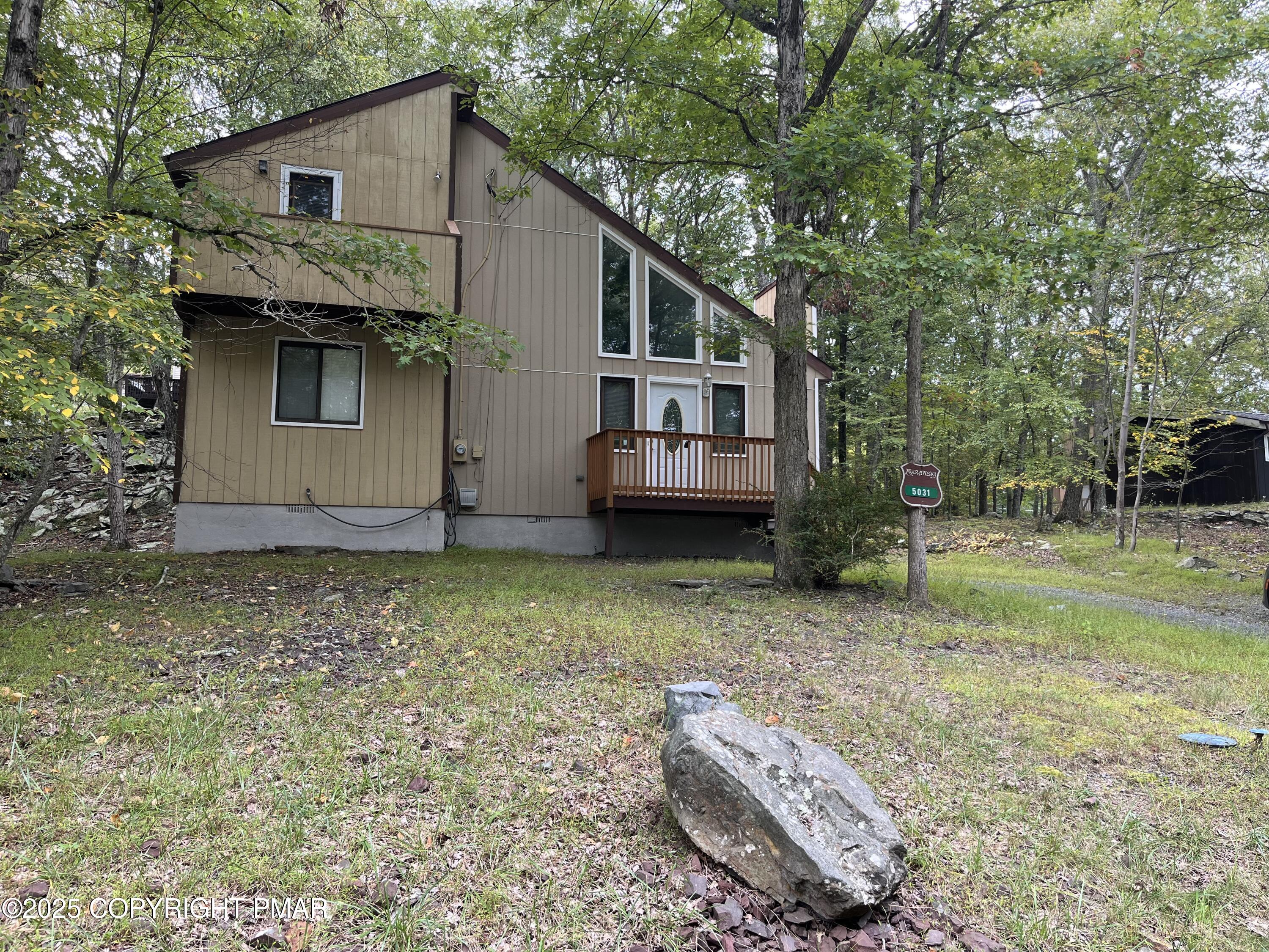 5031 Woodbridge Drive East Bushkill, PA 18324 - Photo 1 of 17 a view of a house with a yard