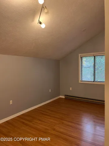 a bathroom with a sink a toilet a window and vanity