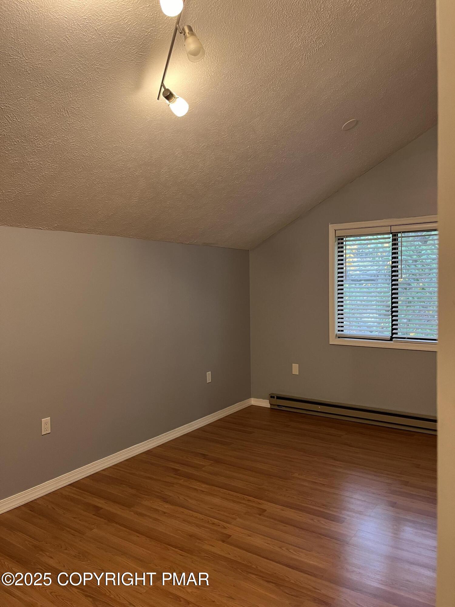 5031 Woodbridge Drive East Bushkill, PA 18324 - Photo 14 of 17 an empty room with wooden floor and windows