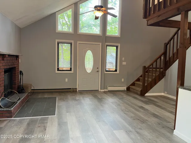 a view of an entryway with wooden floor