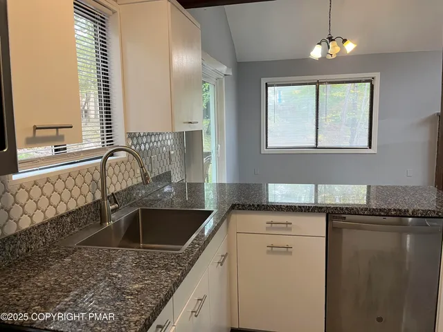 a kitchen that has a sink and a stove