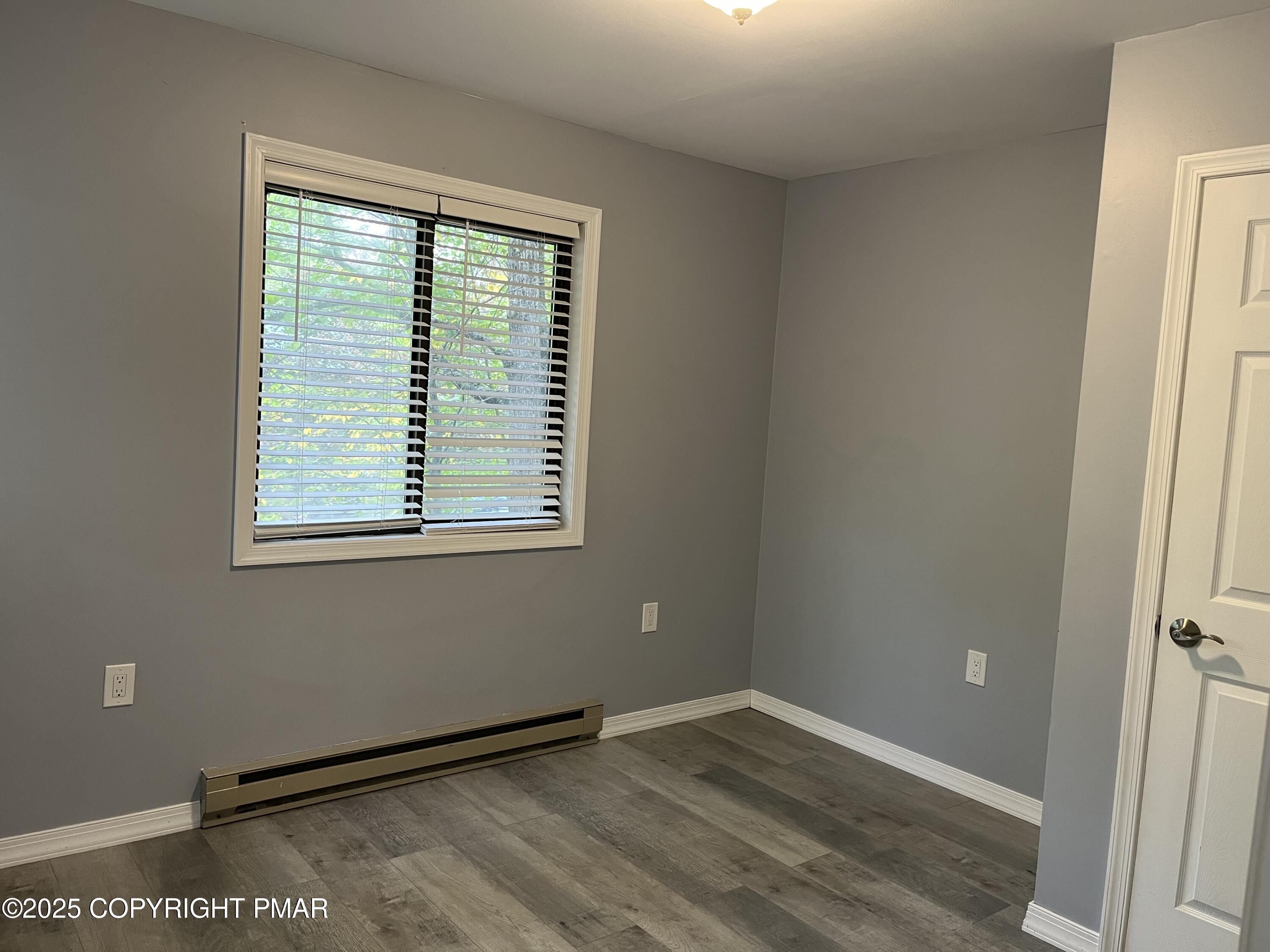 5031 Woodbridge Drive East Bushkill, PA 18324 - Photo 9 of 17 an empty room with wooden floor and windows