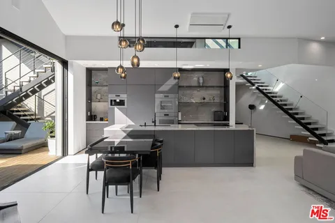 a kitchen with a table and chairs