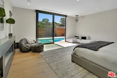 a bedroom with a bed and a couch