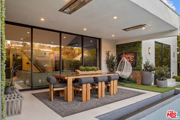 a living room with large windows and furniture