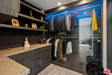 a living room with furniture flat screen tv and a table