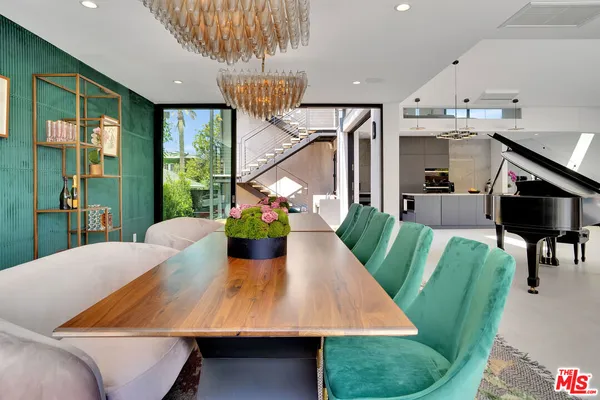a view of a dining room with furniture a chandelier and wooden floor