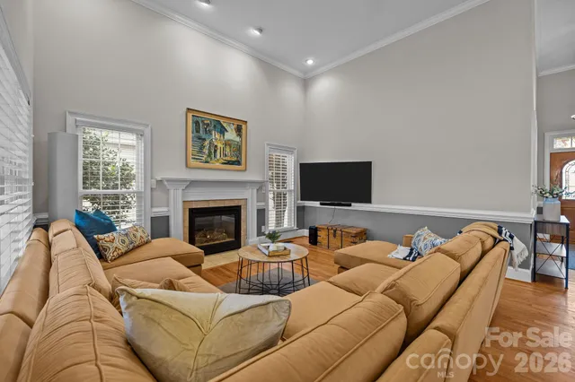 a living room with furniture wooden floor and a fireplace