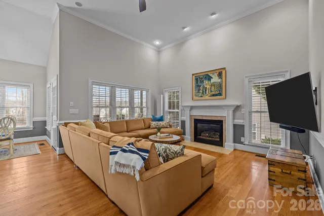 a living room with fireplace furniture and a flat screen tv