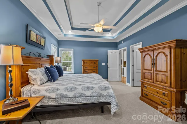 a bedroom with a bed next to a window