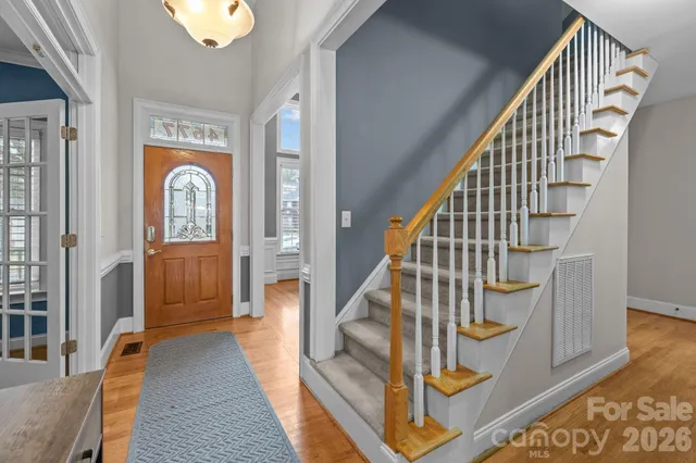 a view of staircase with railing and a rug