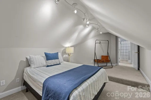 a spacious bedroom with a bed and a large window