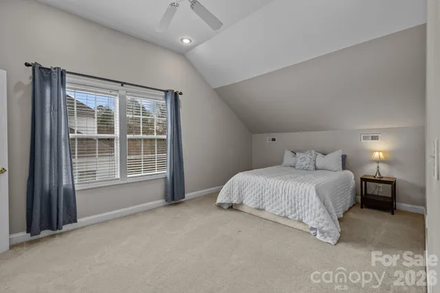 a bedroom with a bed and a night stand