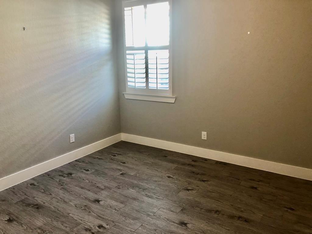229 Riley Lane Fredericksburg, TX 78624 - Photo 14 of 16 wooden floor and window in an empty room