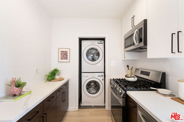 a utility room with sink dryer and washer