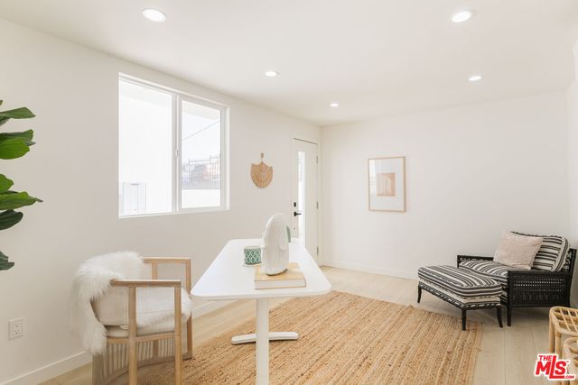 a spacious bedroom with a bed and a chair