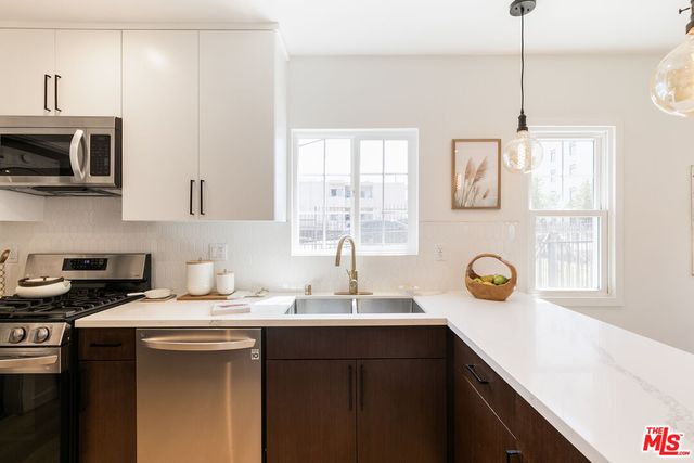 a kitchen with a sink cabinets and window
