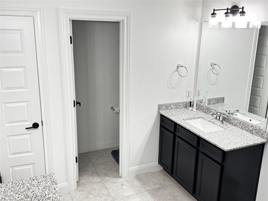 302 Georgia Lace Trail Georgetown, TX 78626 - Photo 15 of 21 a bathroom with a granite countertop sink and a mirror