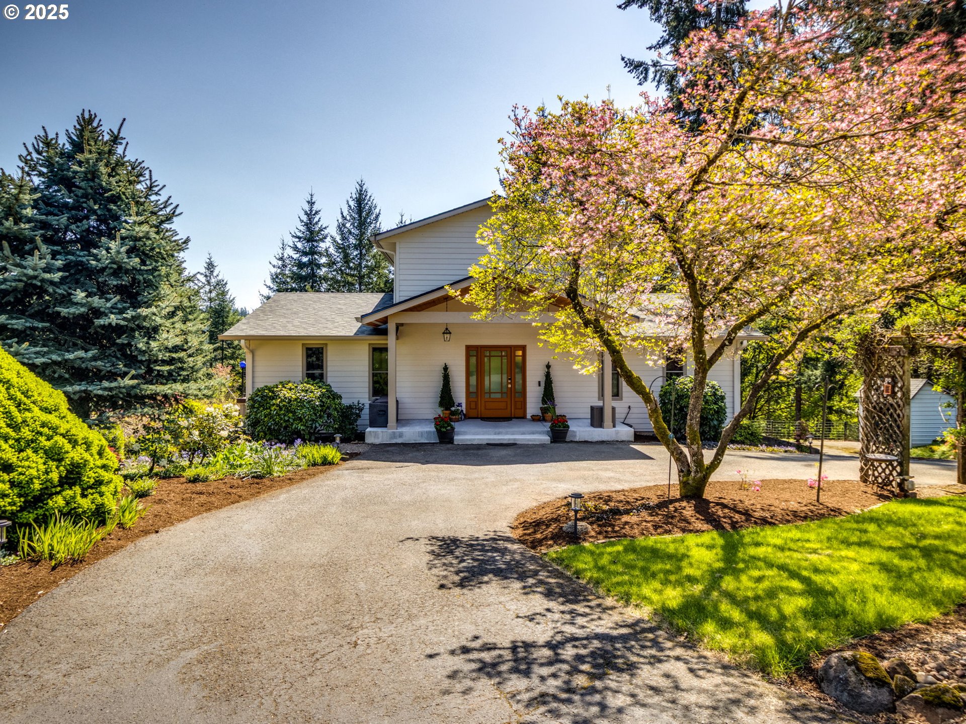a front view of a house with a garden and outdoor seating