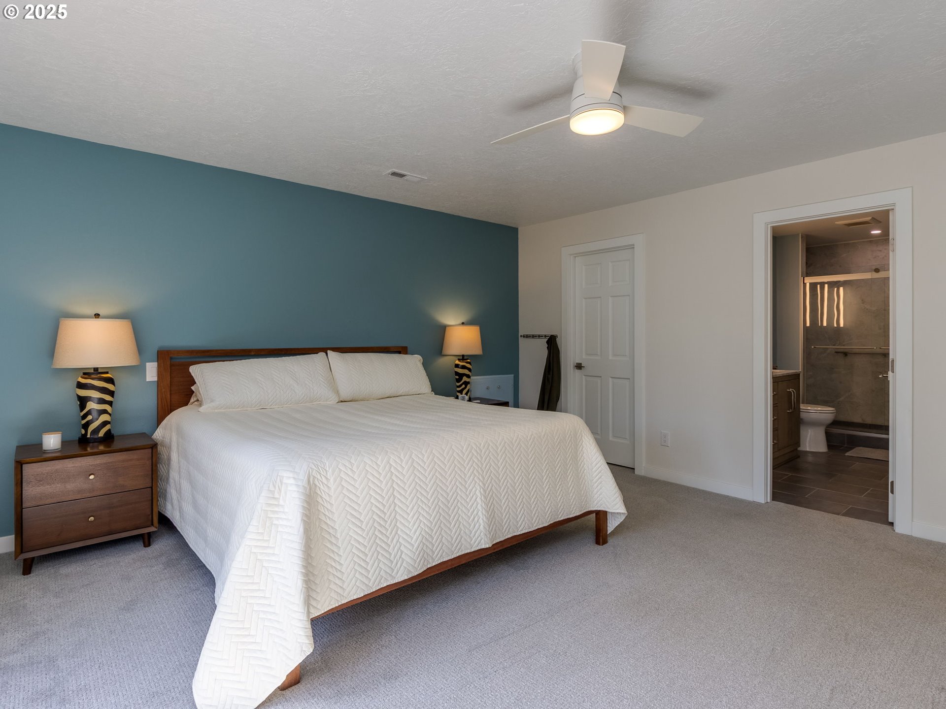 12720 South Carus Road Oregon City, OR 97045 - Photo 15 of 41 a bedroom with a bed and a chandelier
