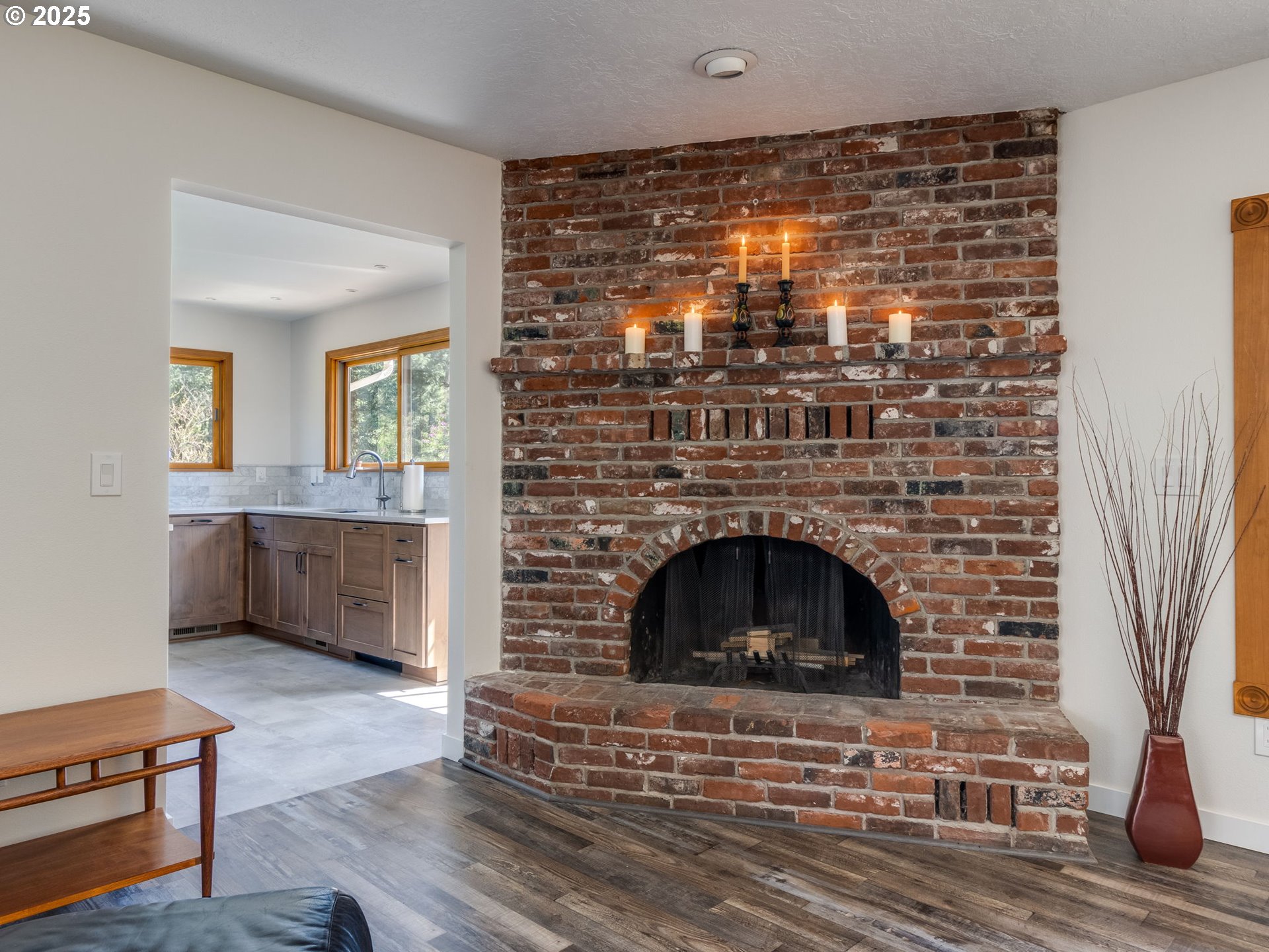 12720 South Carus Road Oregon City, OR 97045 - Photo 6 of 41 a living room with a fireplace and a wooden floor