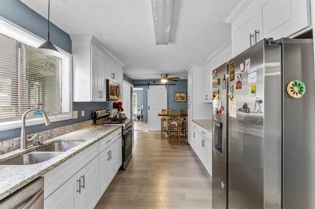 a view of a dining room with furniture and a chandelier