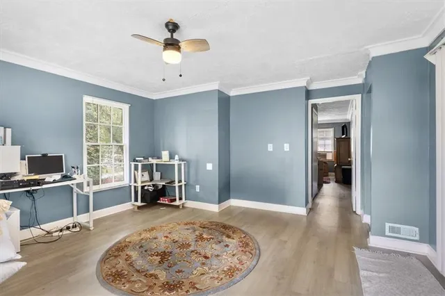 a view of a room with wooden floor