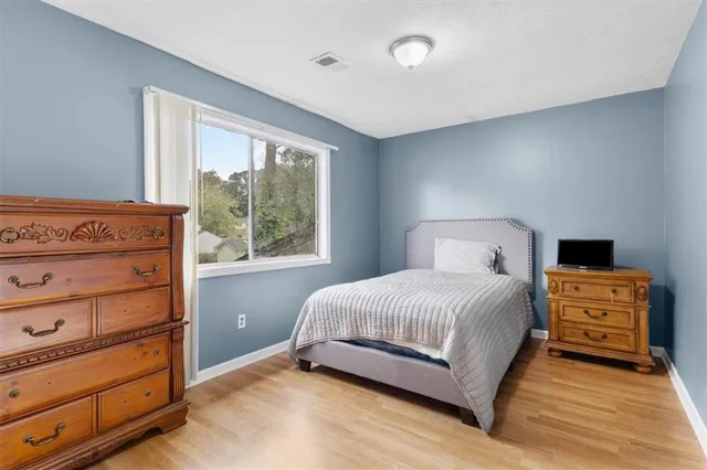 a view of a room with lots of furniture and a potted plant