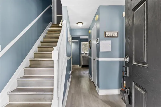 a living room with furniture and floor to ceiling window