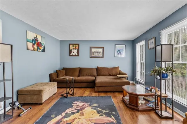 a living room with furniture and a book shelf
