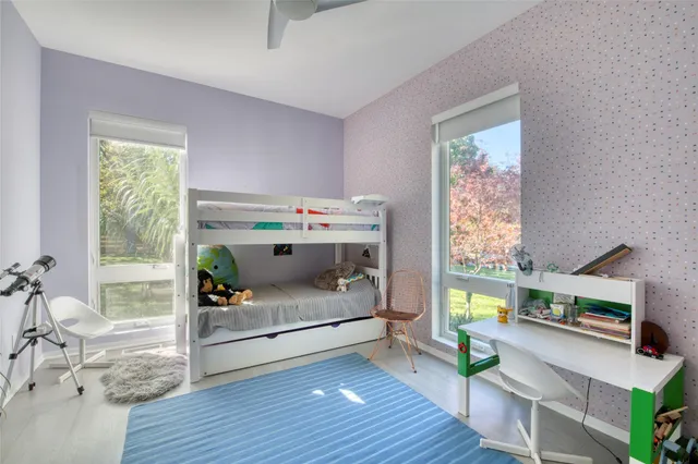 a bedroom with furniture and a wooden floor