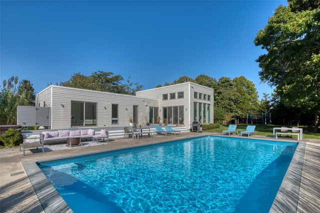 a view of a swimming pool with outdoor seating
