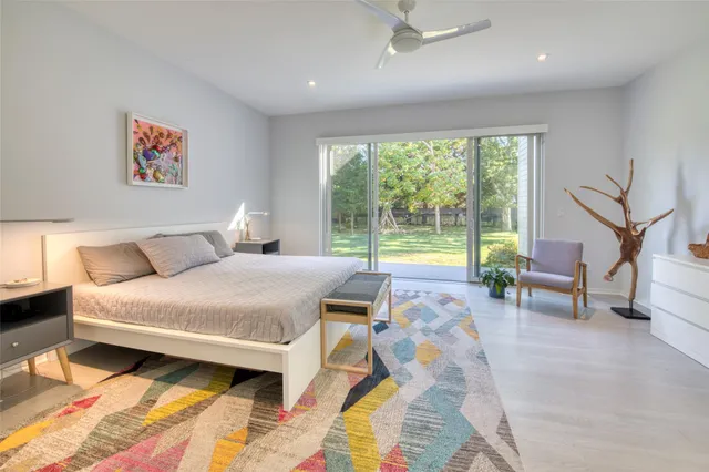 a bedroom with a bed and a night stand