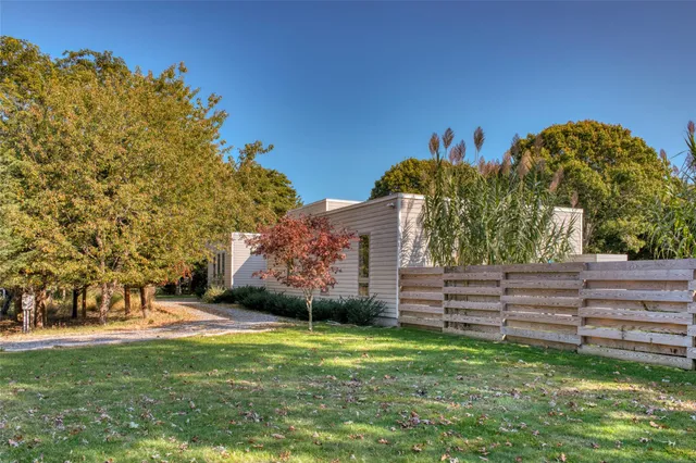 a view of a garden with large trees