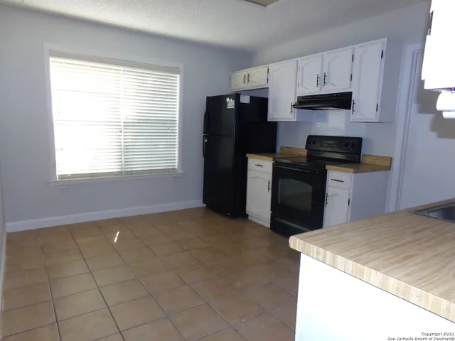a kitchen with a stove a refrigerator and a sink