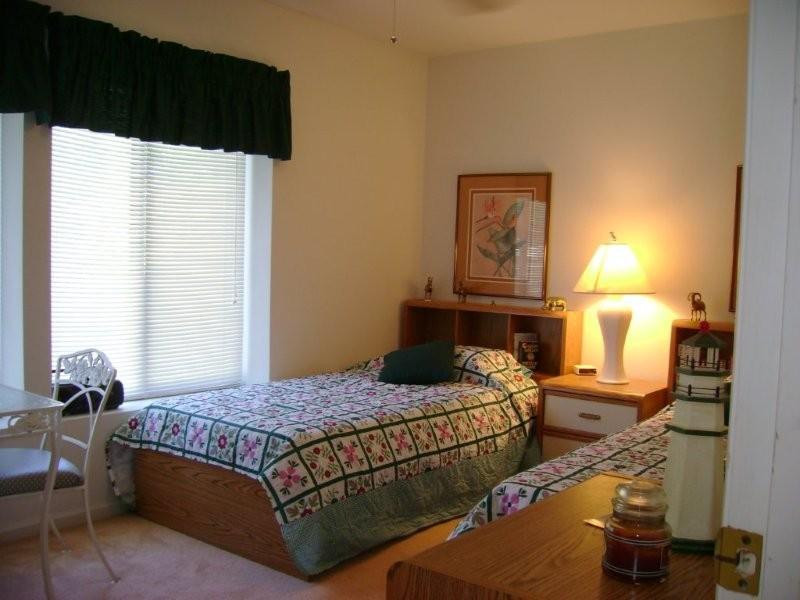 103 Harbor Ridge Drive Goodview, VA 24095 - Photo 6 of 15 a bedroom with a bed and wooden floor