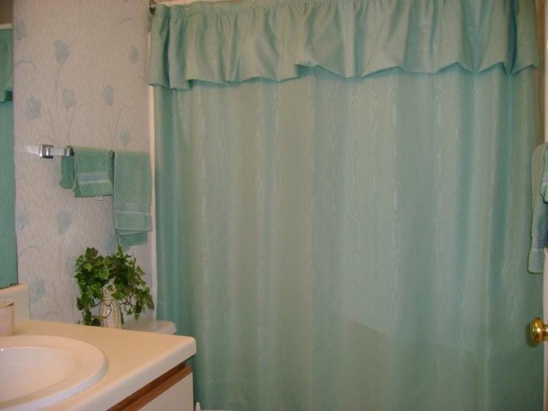 103 Harbor Ridge Drive Goodview, VA 24095 - Photo 7 of 15 a bath room with a shower curtain and a sink