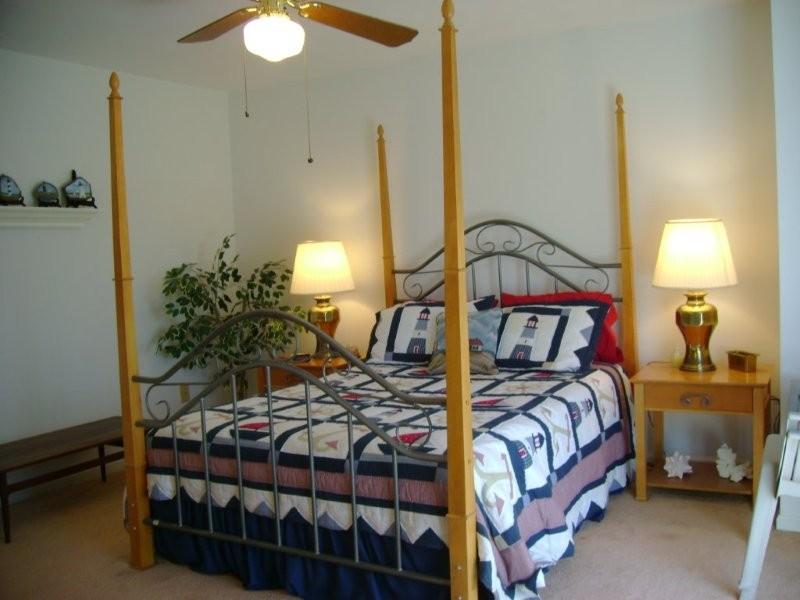 103 Harbor Ridge Drive Goodview, VA 24095 - Photo 8 of 15 a bedroom with a bed and a lamp