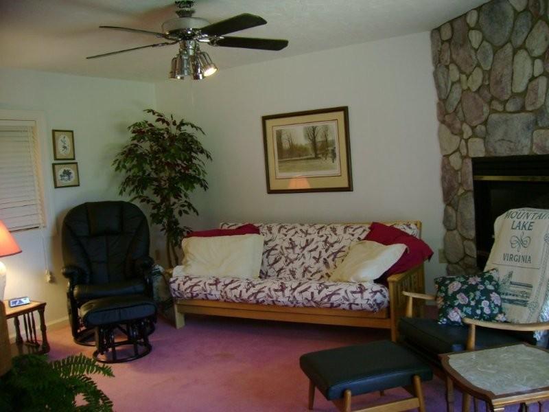 103 Harbor Ridge Drive Goodview, VA 24095 - Photo 10 of 15 a bedroom with a bed a couch and potted plant