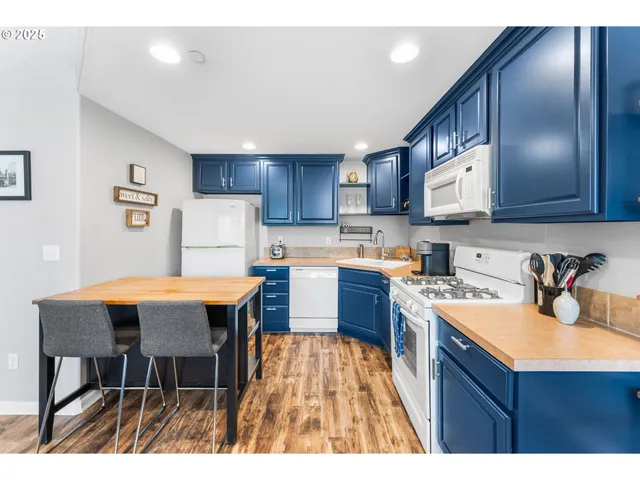 a kitchen with a sink refrigerator and cabinets